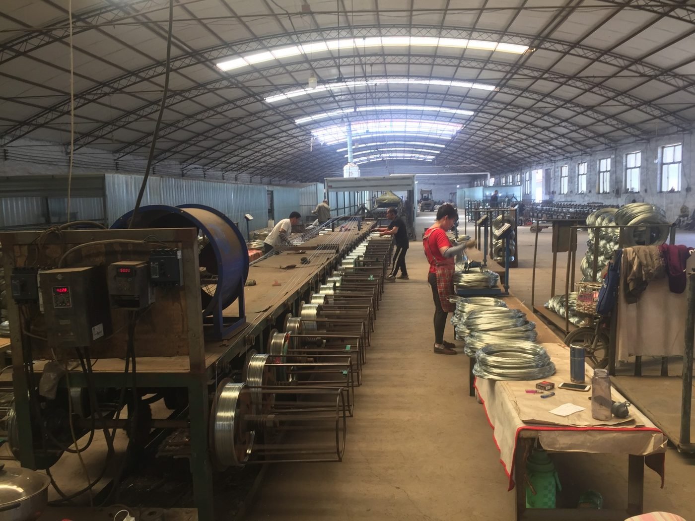 Galvanized fence wire coils in production